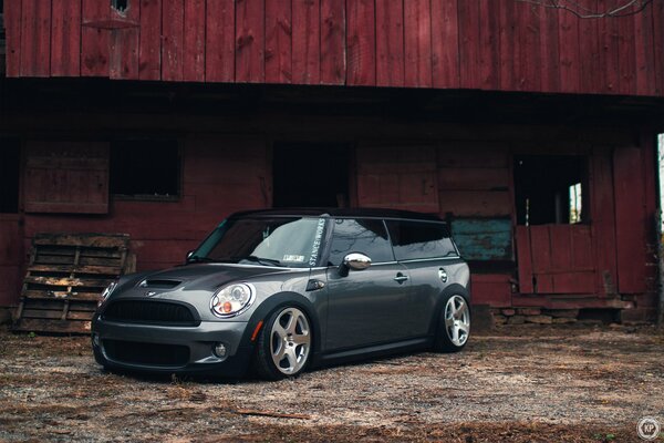 Minicuper glitters with new alloy wheels on the background of abandonment