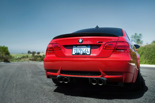 Red BMW on the road rear view