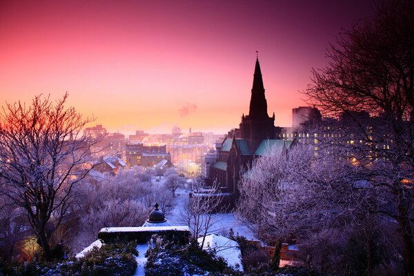 Snow-covered city in the evening