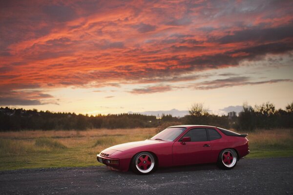 Red Porsche on the background of a red sunset