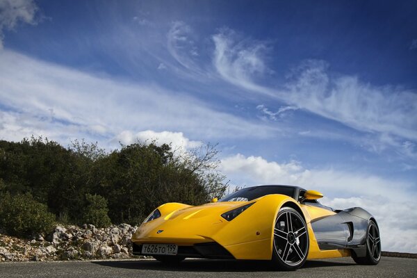 A sporty yellow car on the road