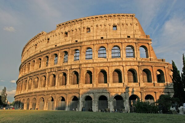 The majestic building of the Colosseum at sunset delights