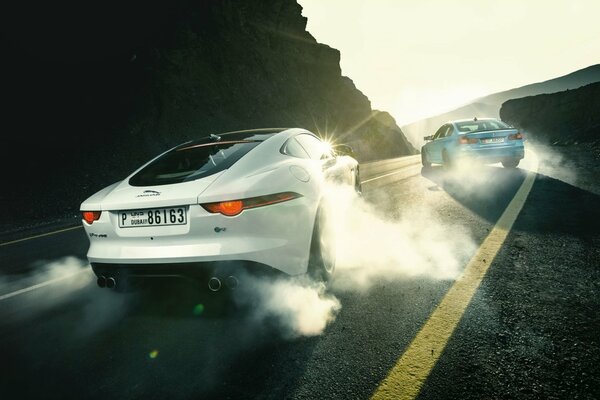 Jaguar and BMW sports cars drift