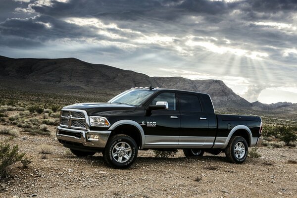 Pickup truck on the background of mountains and desert