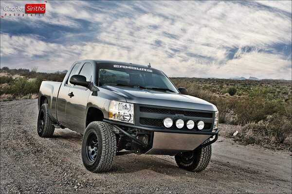 Chevrolet Silverado on the road against the sky with clouds