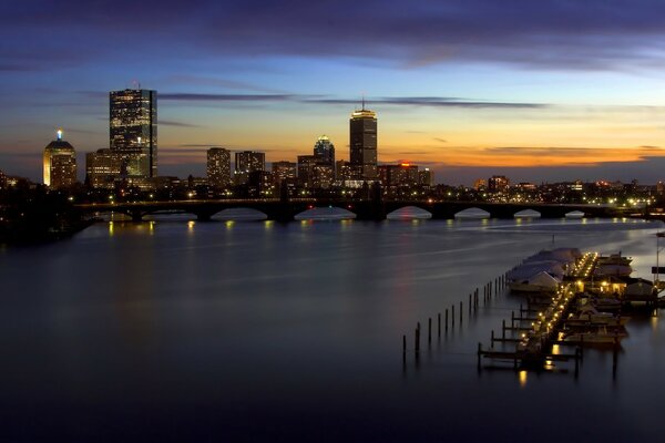 Evening pier on the background of the bridge and the city