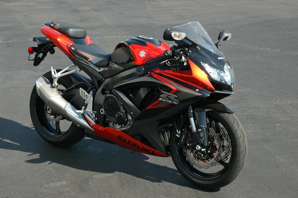 Stylish black and red motorcycle on asphalt