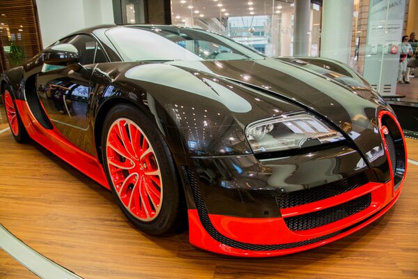 Black bugatti veyron in a car dealership