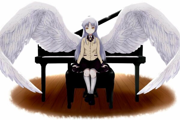 A white angel is sitting at the piano