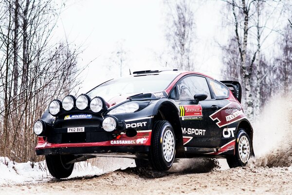 Black Ford Fiesta participates in a race in the snow