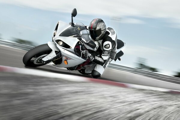 Pilot on a white sport bike smeared background