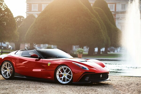 Red Ferrari next to the fountain