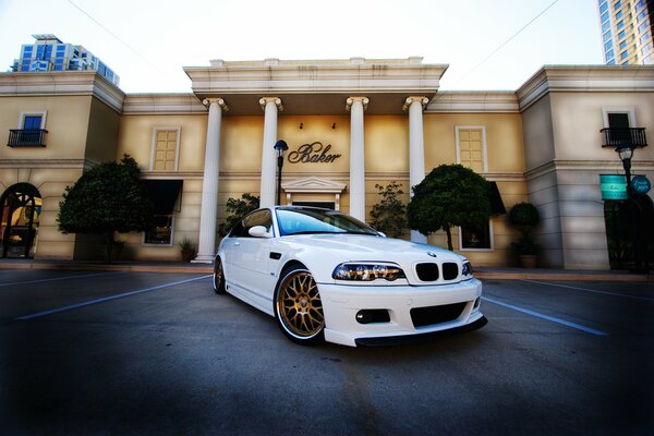 A white BMW m3 drove by the building