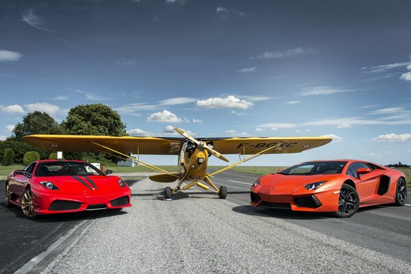 A yellow plane and two red cars