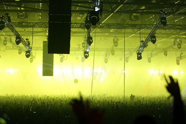 A crowd of fans at a concert in front of the stage