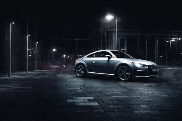 Silver car at night under a streetlight