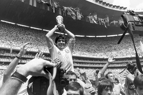 Black and white photo of the winner with the cup