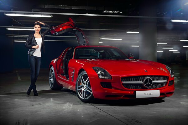 Photo of a red Mercedes-benz in an underground parking lot with a girl at an open door