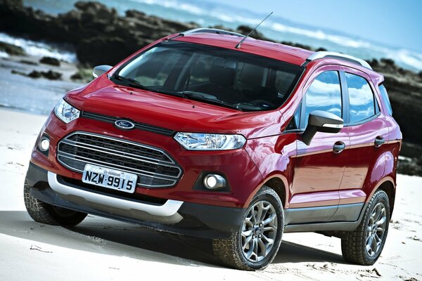 Bright red Ford Ecosport crossover on the riverbank