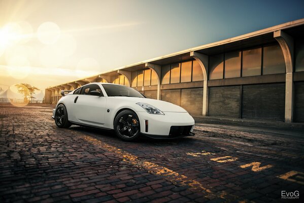 White Nissan nismo on sunset background