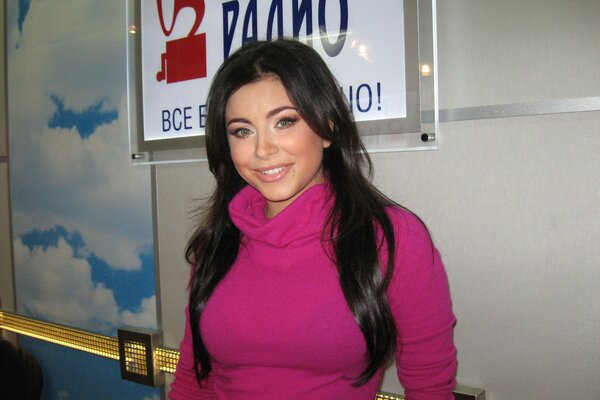 Beautiful brunette in a pink sweater