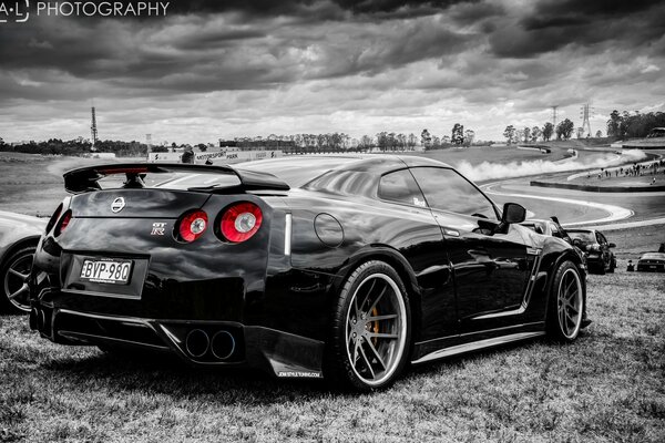 Black r35 nissan skyline car on sky background