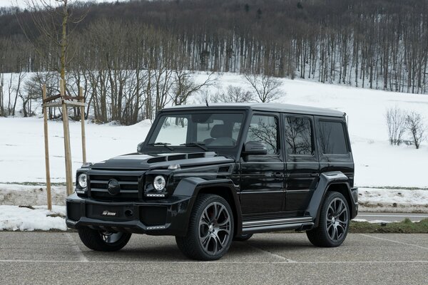 Mercedes Benz G-class on the background of a snowy forest