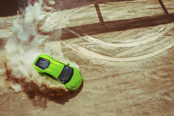 Drift of a green car on the sand