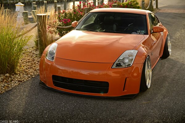 Small Orange Nissan 350z with large headlights