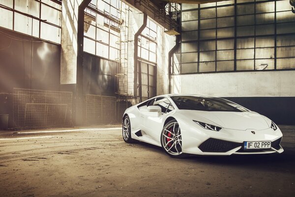 The newest supercar is a white Lamborghini. Front view