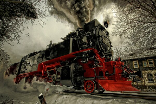 Una locomotiva a vapore disegnata cavalca su binari innevati