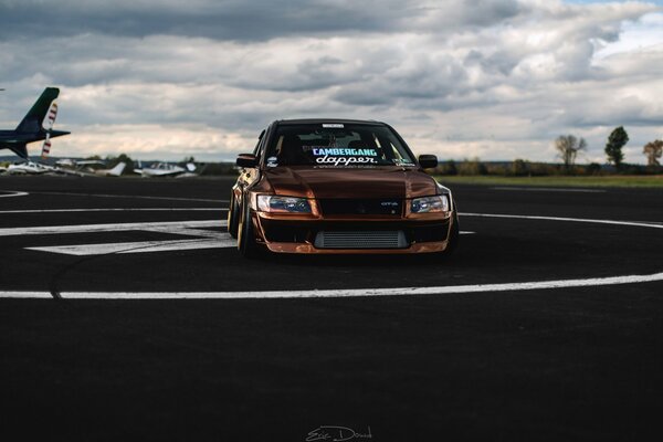 Mitsubishi car on the background of the road and clouds