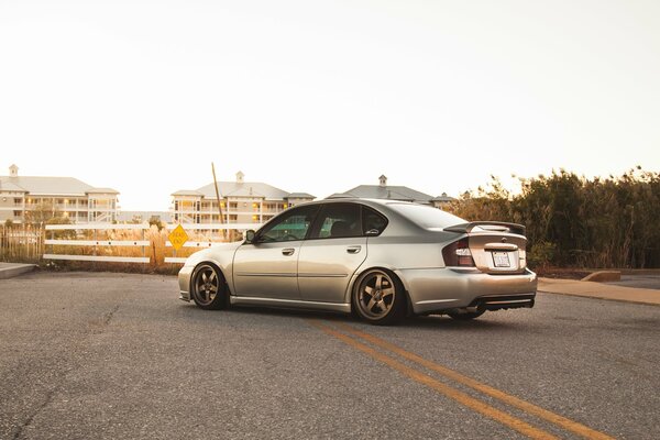 Subaru legacy at sunset on the dividing strip