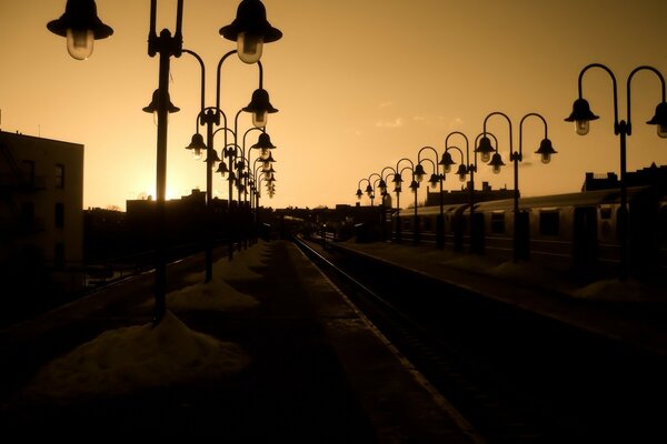 Alte Laternen entlang der Eisenbahn bei Sonnenuntergang