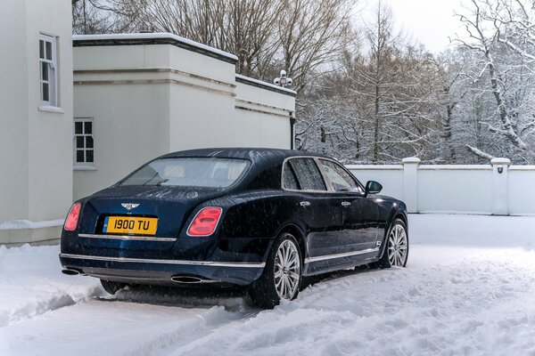 A blue car in the snow is ordinary