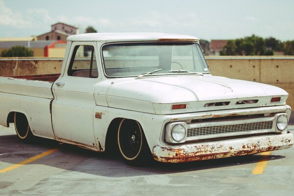 Vieux blanc pick-up dans le parking