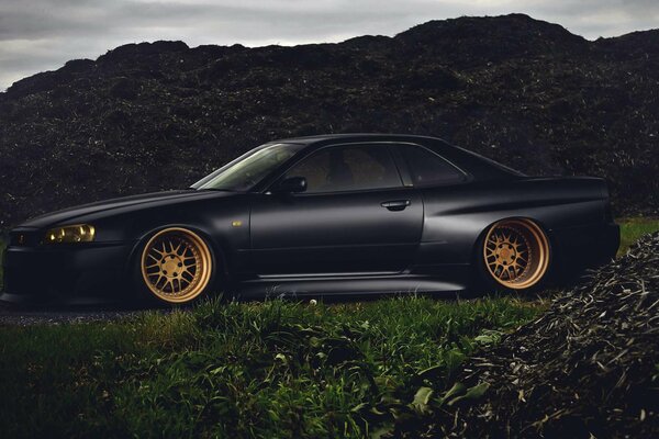 Black matte car on the background of mountains