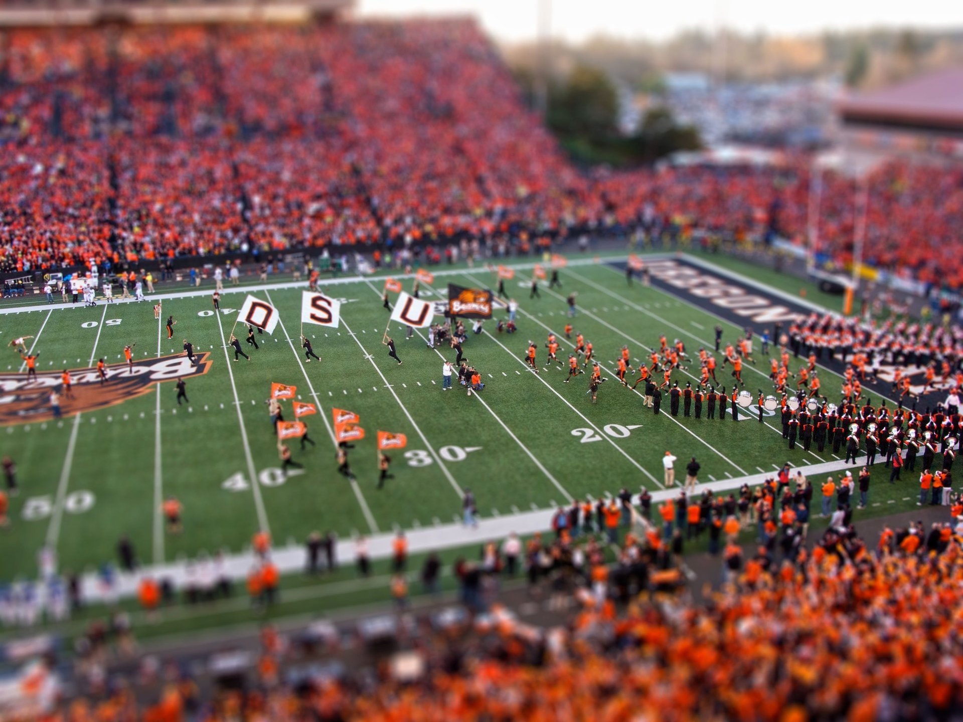 miniatur sport wirkung feld stadion rasen zahlen menschen orange tilt-shift farbe