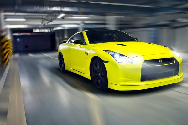 Yellow sports car in the parking lot in motion