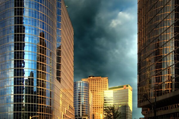 Glass buildings of the city against a cloudy sky