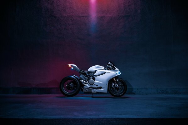 Ducati 1199s motorcycle in the dark under a spotlight