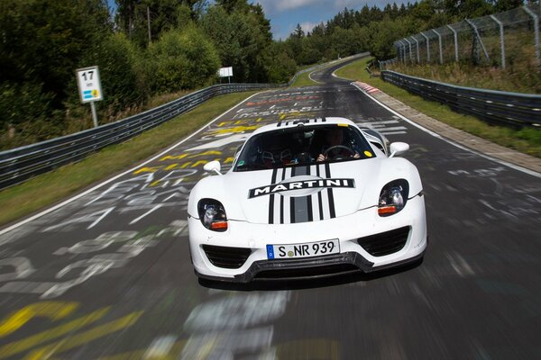 White tuning car rushes down the road