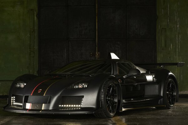 A beautiful supercar is depicted in semi-darkness