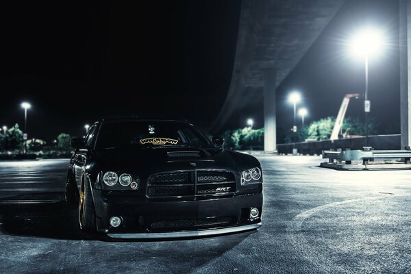 American car at night by the light of lanterns