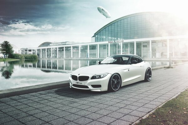 White bmw z4 parked by the lake