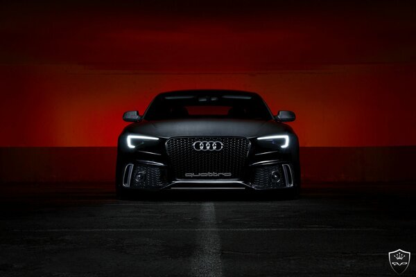 Black Audi on the background of a bloody sunset