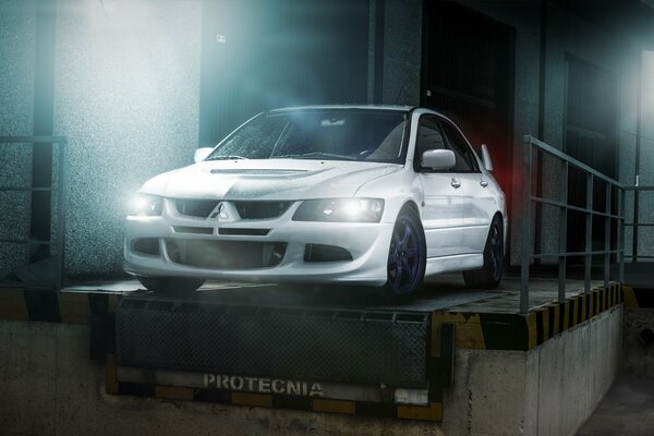 White mitsubishi evolution , white Mitsubishi evolution in the hangar, white Mitsubishi evolution at night, white Mitsubishi evolution with headlights on