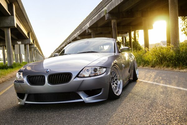 Silver car on the background of the bridge