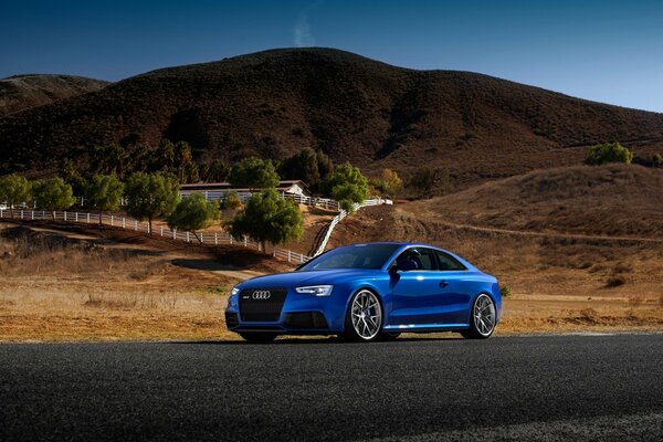 Audi rs5 blue sports car on the road