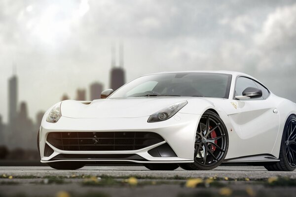 White Ferrari on the background of an urban silhouette